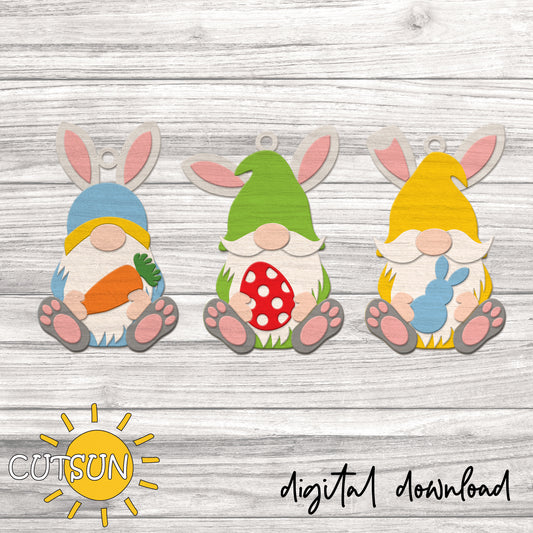 Three colorful gnome cutouts with bunny ears on a wooden background, featuring the brand 'CUTSUN'.