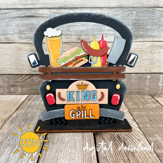 A digital rendering of a grill master sign with a farmhouse style, featuring a truck with various food items and a sign that says 'King of the Grill'.