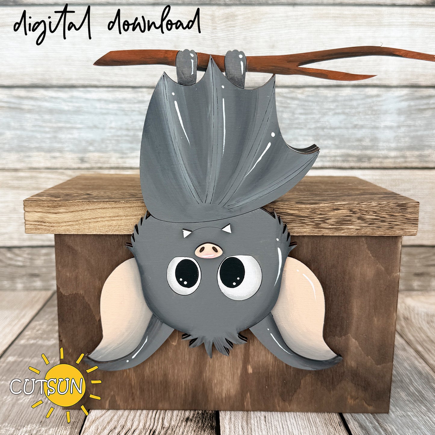 Cute upside-down bat shelf decoration SVG hanging from a shelf edge using a hidden rear support, designed as a layered Halloween laser cut file.