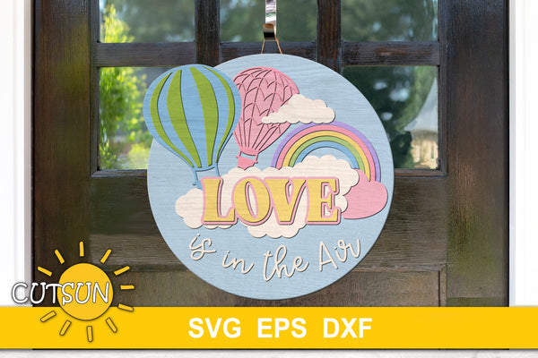 SVG digital download for a door hanger featuring two hot air balloons, a rainbow and the words "Love is in the air"