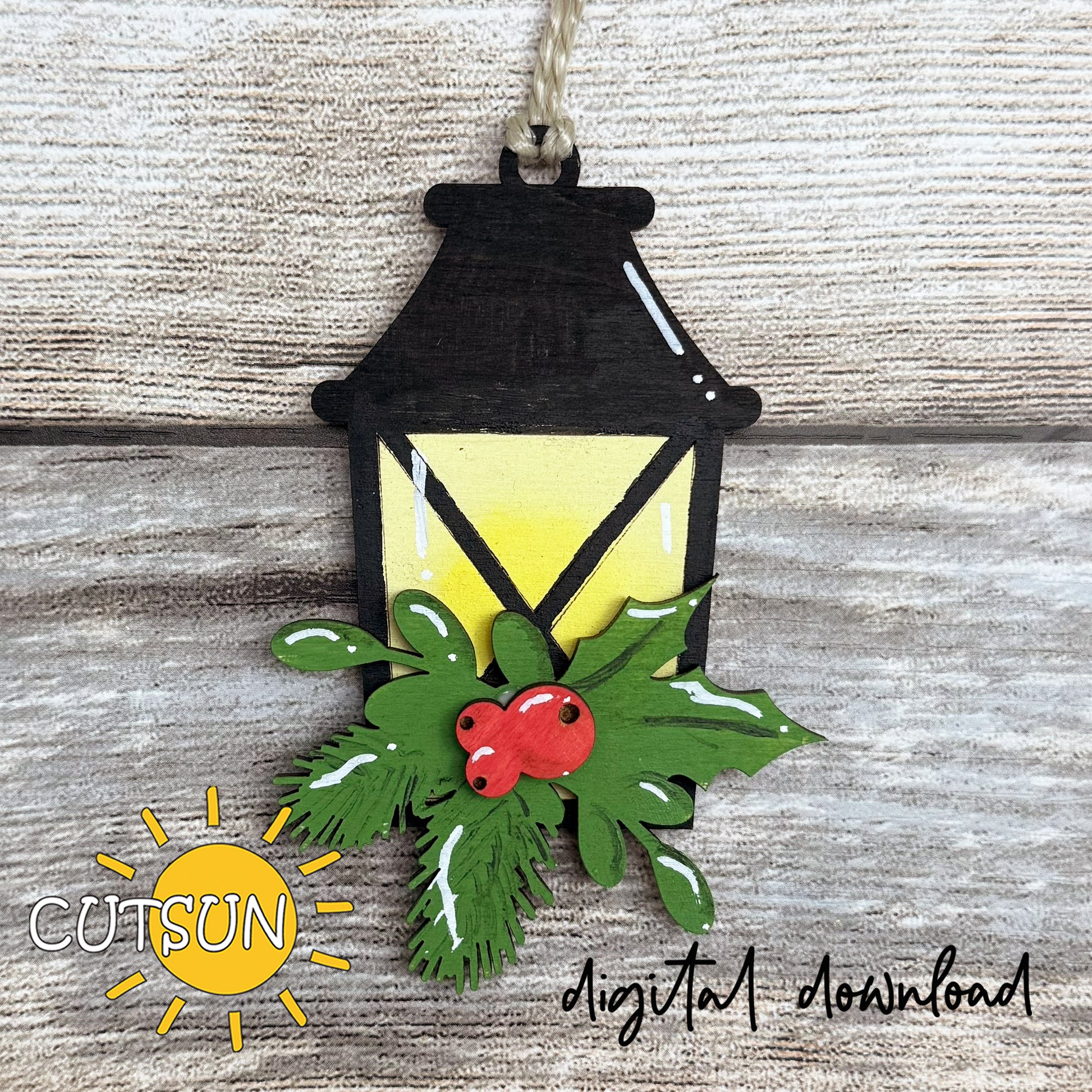 Layered lantern Christmas ornament with pine branches and holly berries, painted yellow glow, digital laser cut SVG by CutsunSVG.”