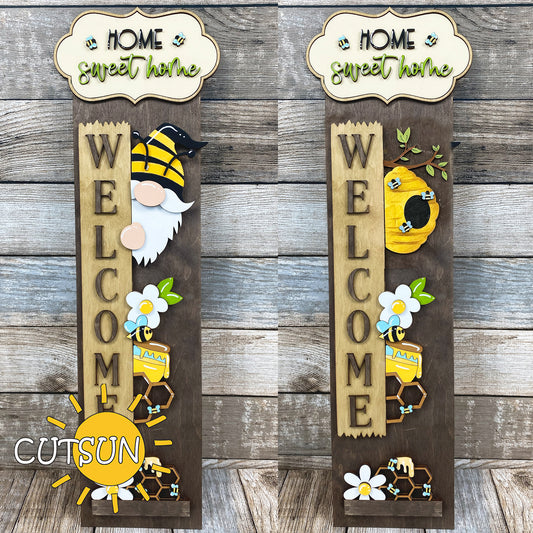 Two wooden signs with gnomes, flowers, and honeycomb designs on a wooden background.