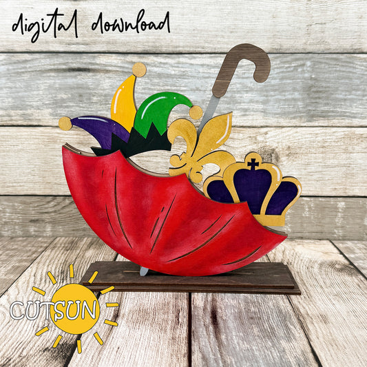 Mardi Gras add-on for interchangeable upside down umbrella shelf sitter featuring jester hat, fleur-de-lis, and crown in purple, green, and gold layered laser cut design