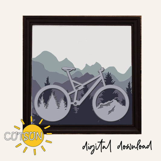 Framed digital artwork of a mountain bike with a mountain landscape in the background, featuring the brand 'CUTSUN'.