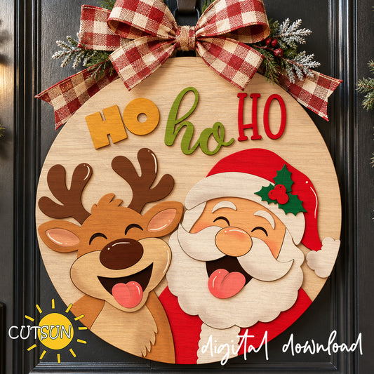 Layered wooden Santa and Reindeer Ho Ho Ho Christmas round door hanger with playful smiling faces, Santa hat, and festive lettering, laser cut SVG design.