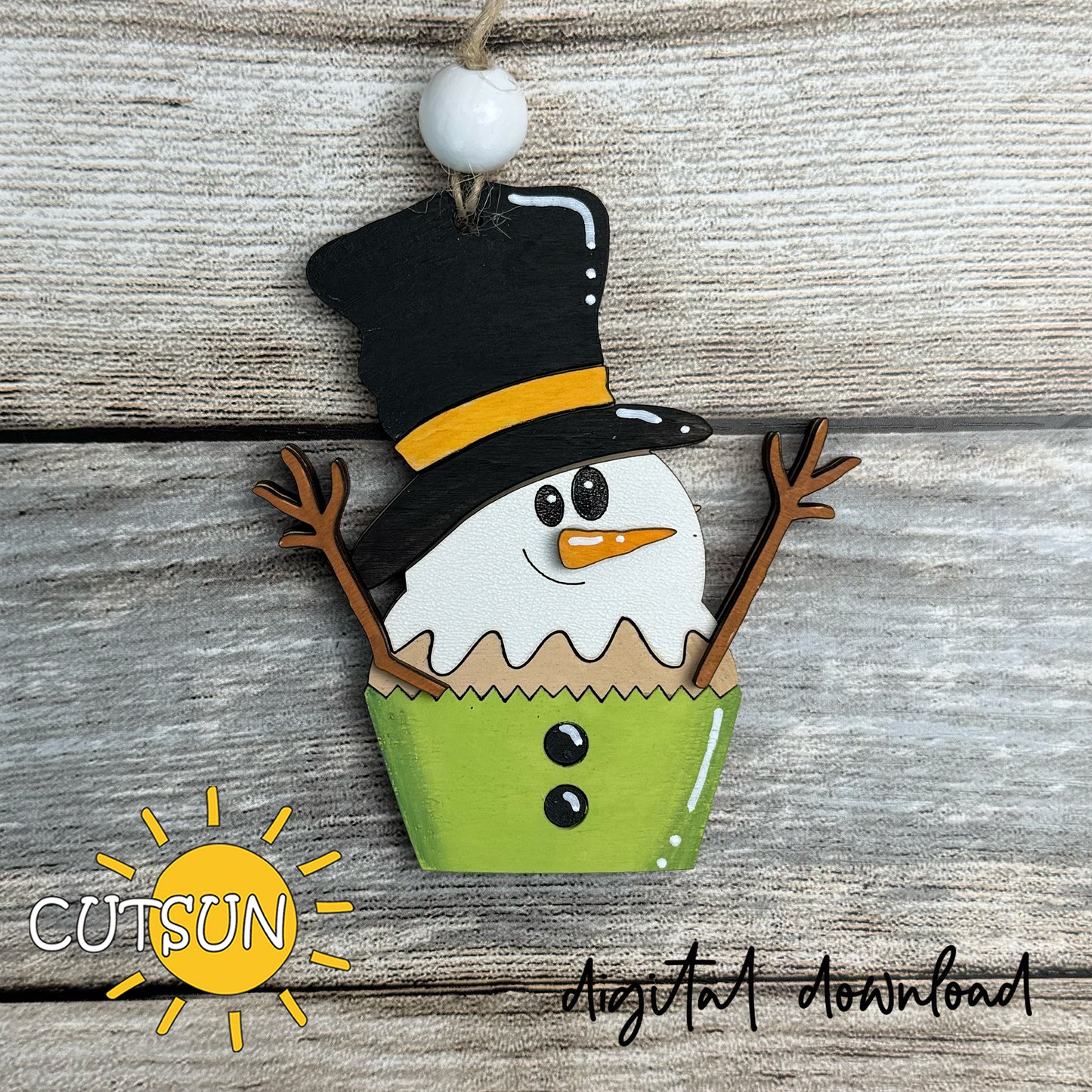 Snowman Cupcake Ornament SVG cut file with layered design featuring a melting snowman in a green cupcake wrapper, Christmas digital download.