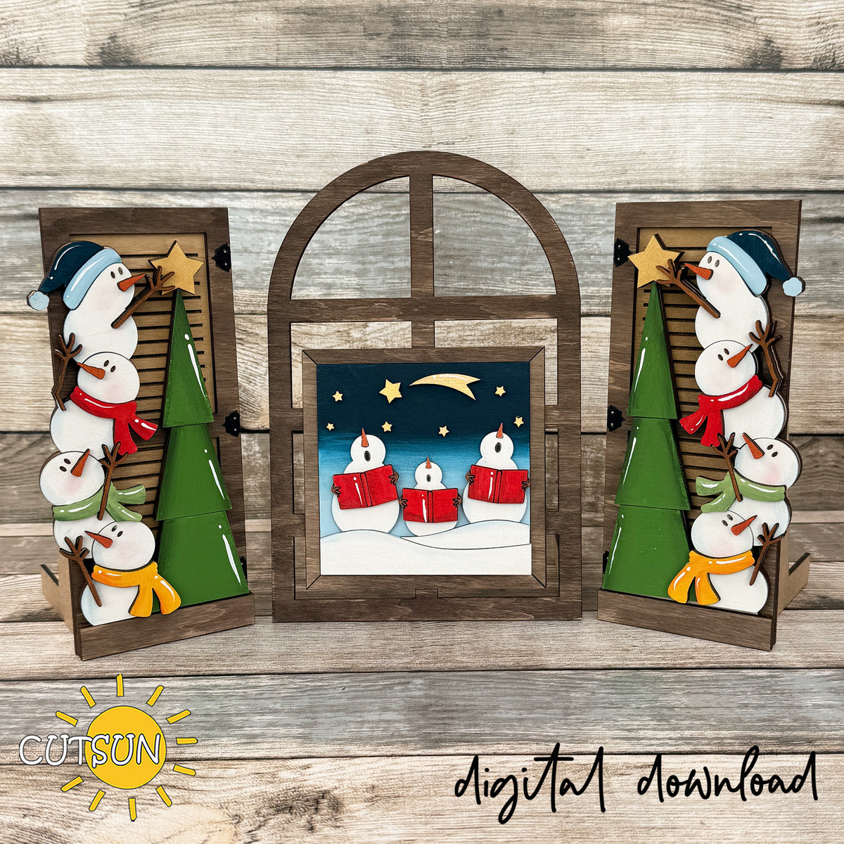 Arched farmhouse window with layered snowmen, star-topped Christmas trees, and a snowman carolers center insert.