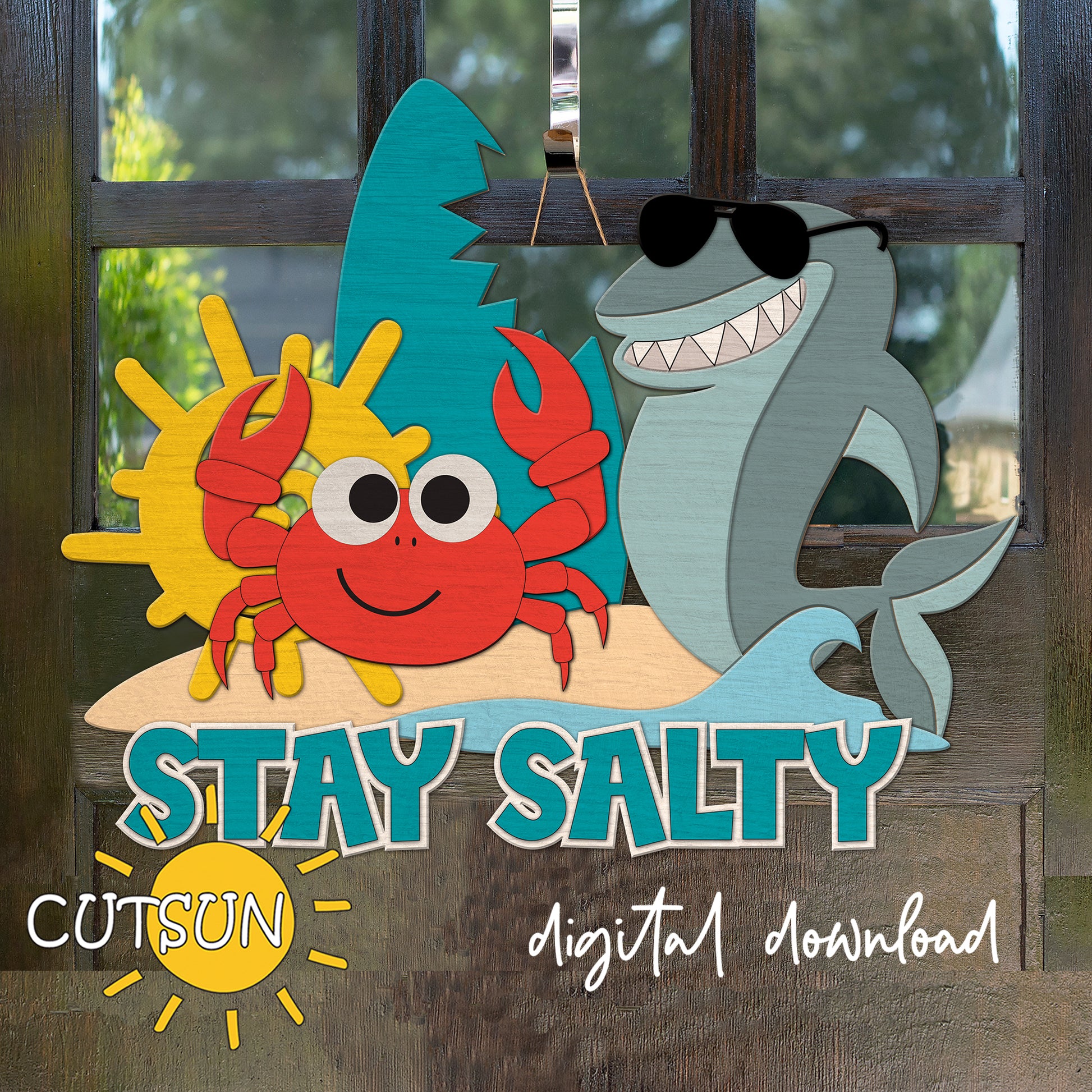 Layered wood door sign with the phrase “Stay Salty,” featuring a smiling red crab, a sunglasses-wearing shark, sun, wave, and beach scene.