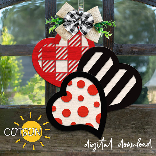 Decorative hearts with plaid and polka dot patterns on a wooden surface, featuring the brand 'CUTSUN'.