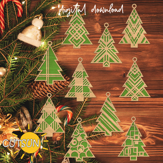 Decorative Christmas tree cutouts on a wooden surface with holiday decorations.
