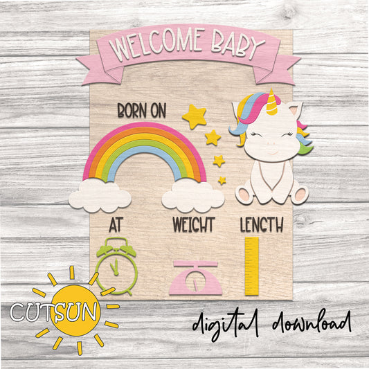 Baby shower sign with unicorn, rainbow, and baby weight and length measurements on a wooden background.