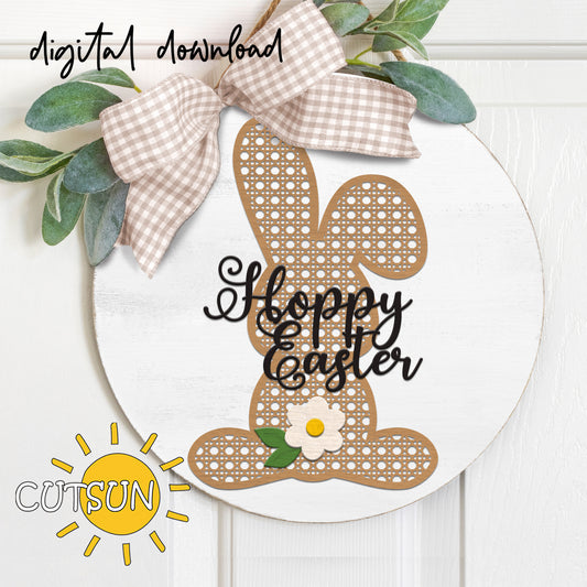 Easter door hanger featuring a rattan cane bunny silhouette, a small daisy and the text Hoppy Easter in a script font.