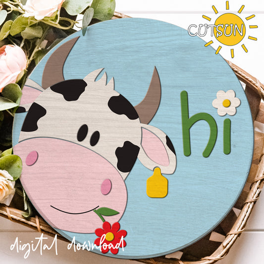 Circular sign with a cow illustration and 'hi' text on a blue background, surrounded by flowers.
