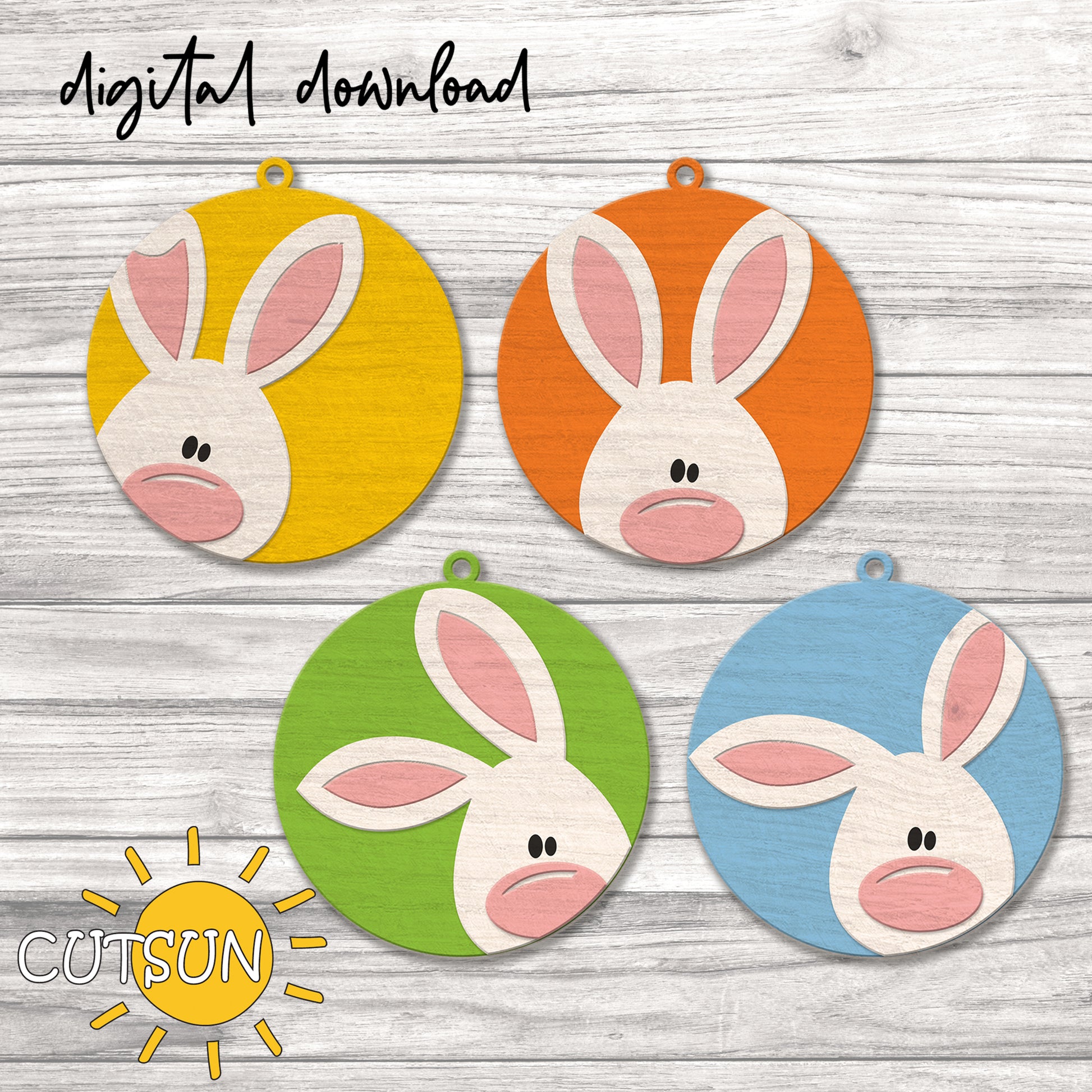 Four colorful bunny face cutouts on a wooden surface with 'CUTSUN' branding.