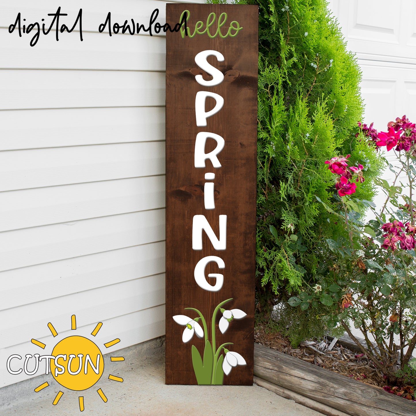 Wooden sign with 'hello spring' text and floral design against a white wall with plants.